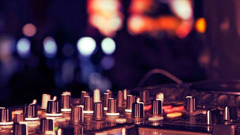 DJ equipment against a blurred club background